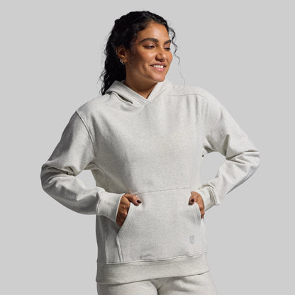Person wearing a light gray hoodie on a plain background