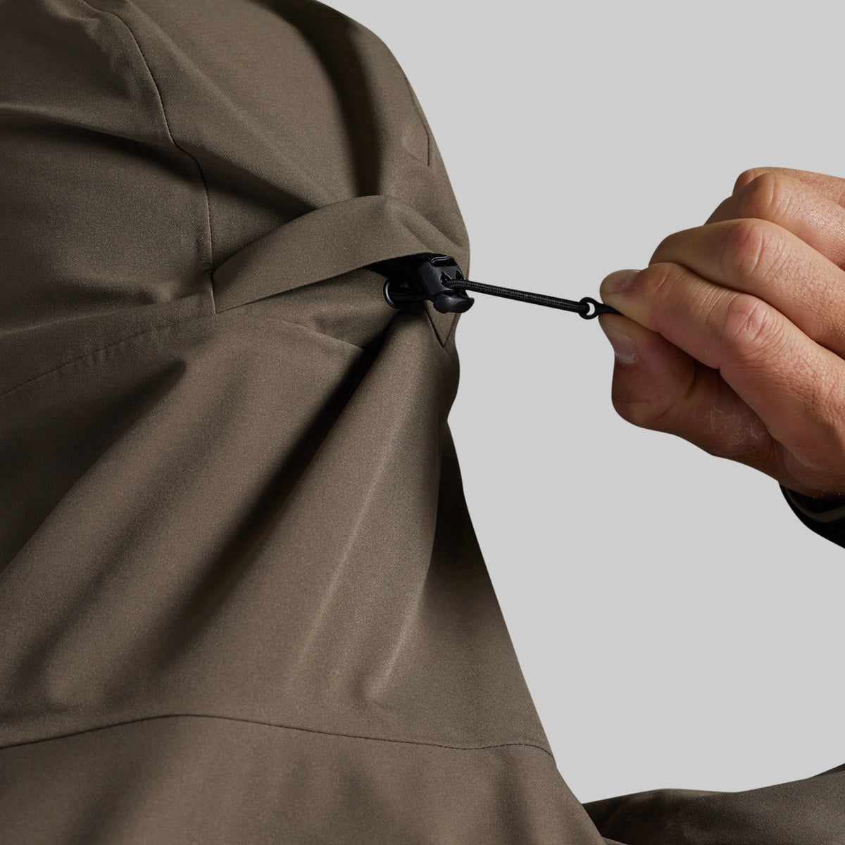 Adjustable waist drawcord on the Ranger Green Mission FLEX Rain Jacket 2.0