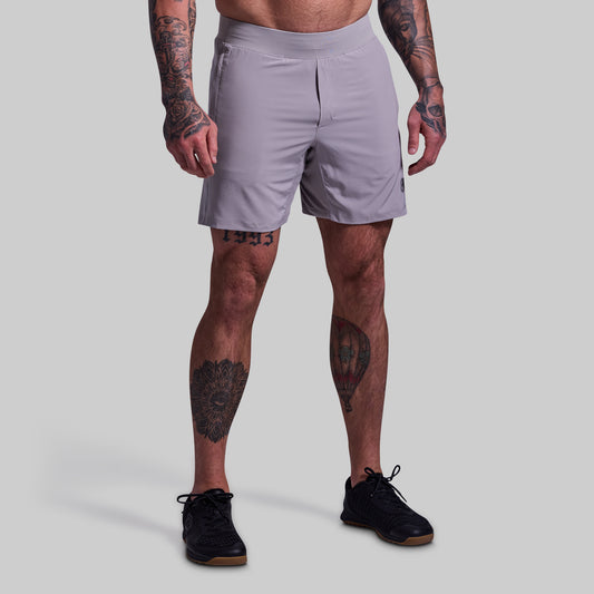 Person wearing light gray athletic shorts on a plain background