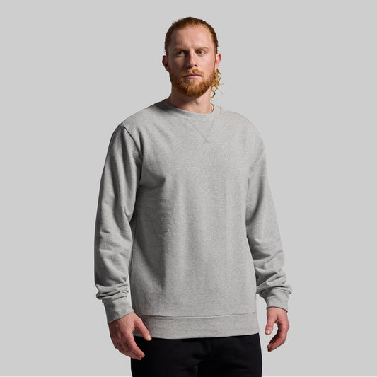 Man wearing a gray sweatshirt against a plain background