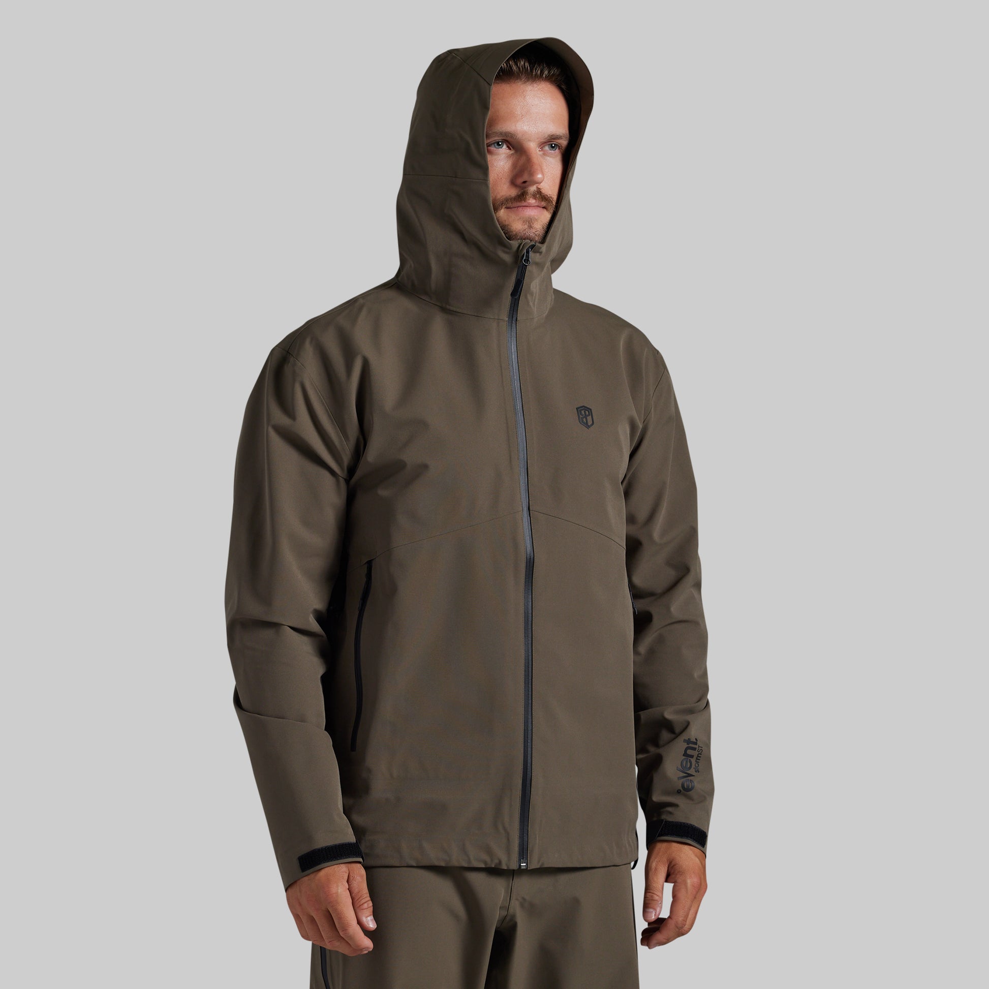 Man wearing the Ranger Green Mission FLEX Rain Jacket 2.0, front view with hood up