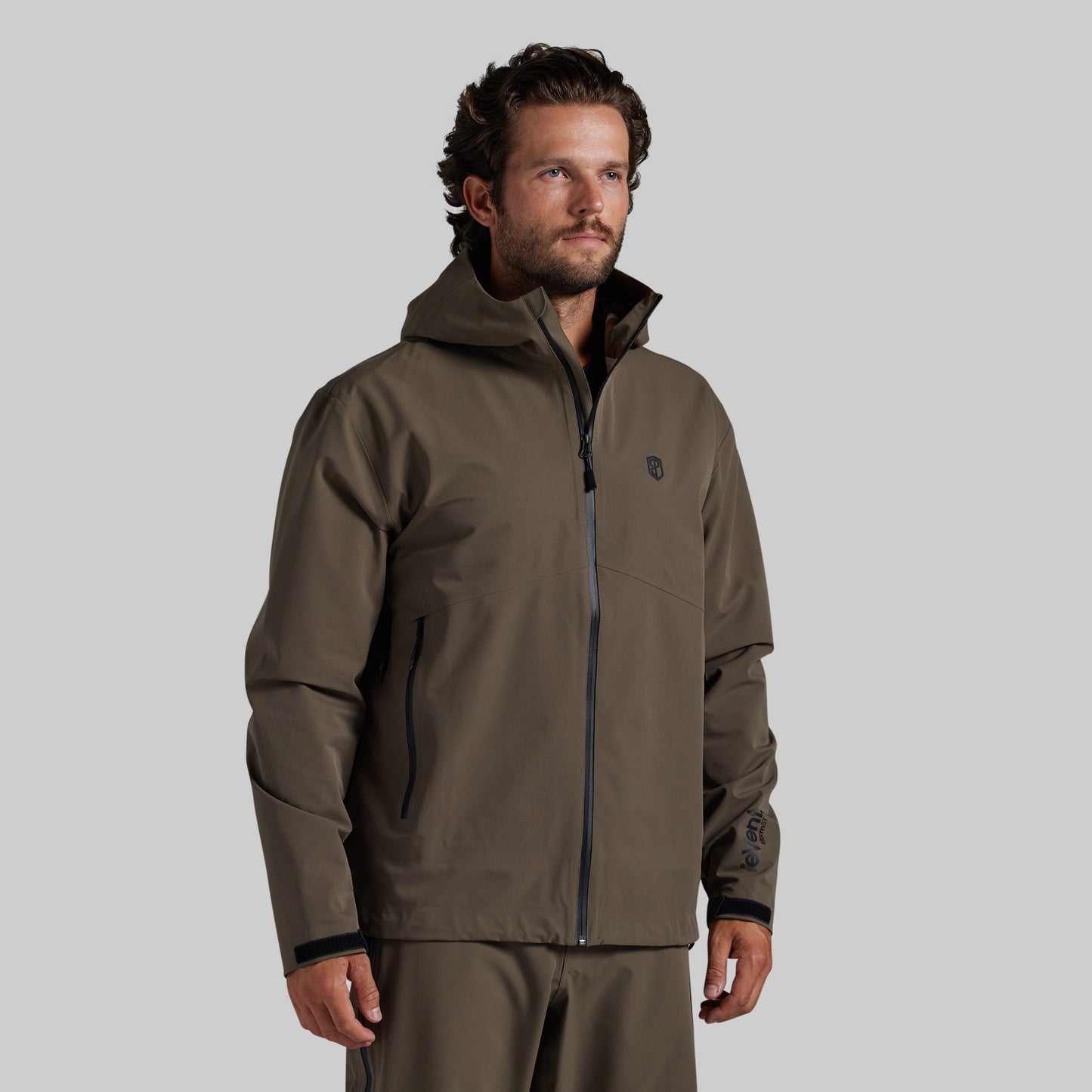 Man wearing the Ranger Green Mission FLEX Rain Jacket 2.0, front view with hood down