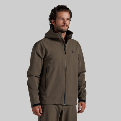 Man wearing the Ranger Green Mission FLEX Rain Jacket 2.0, front view with hood down