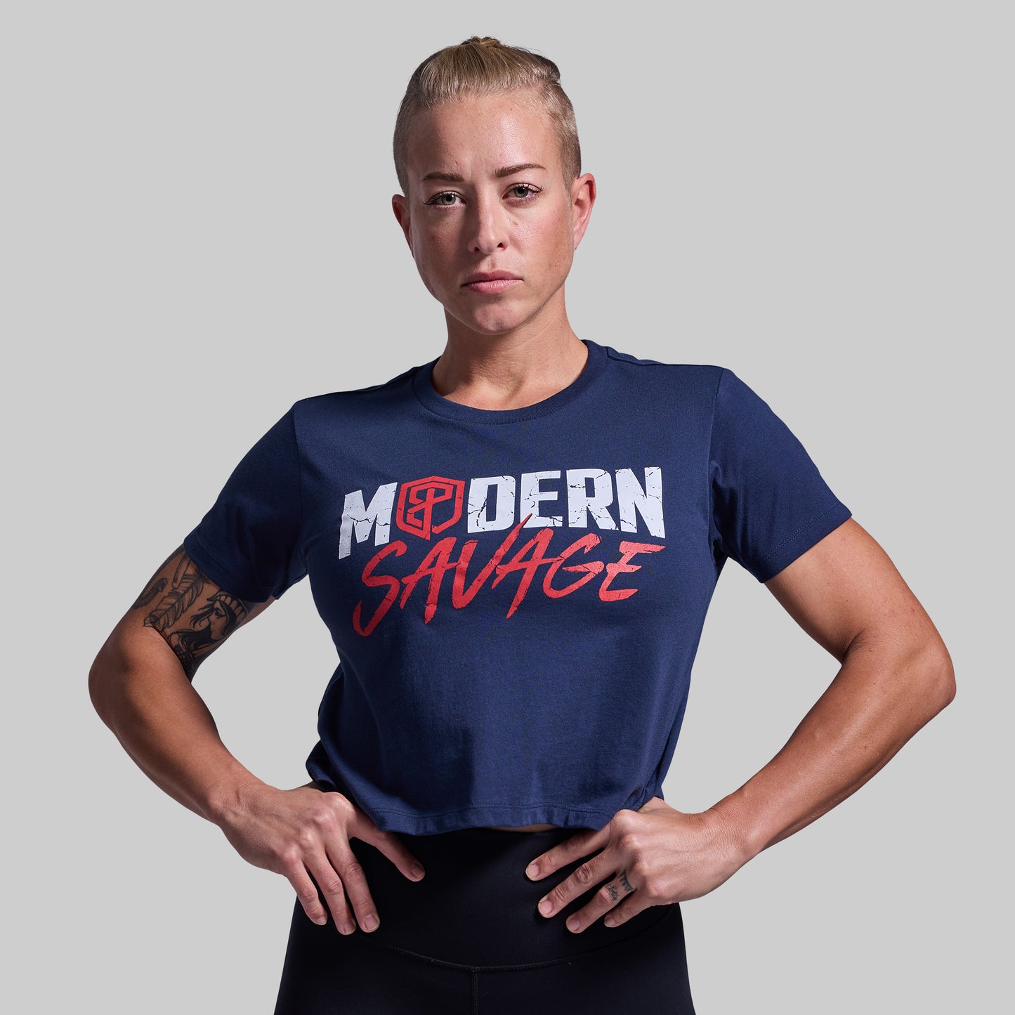 Person wearing a navy blue t-shirt with 'Modern Savage' text on a gray background