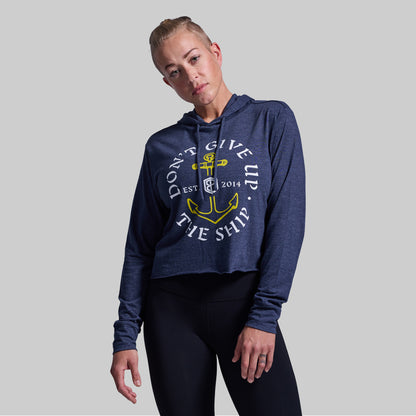 Person wearing a navy blue hoodie with a graphic design on a gray background