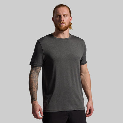 Man wearing a dark gray t-shirt against a plain background