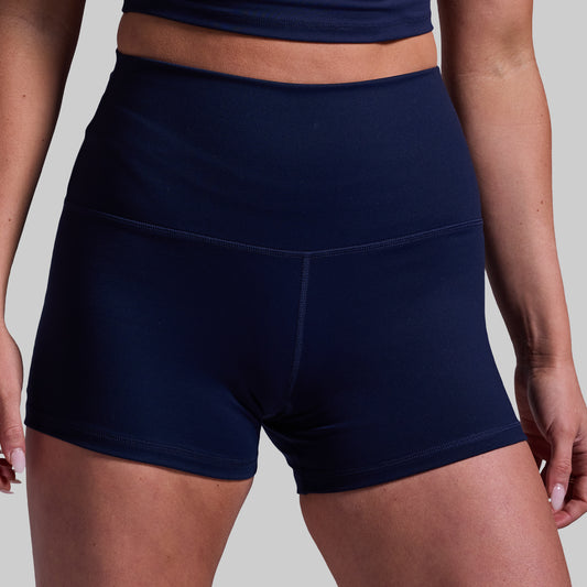 Navy blue athletic shorts worn by a person on a plain background