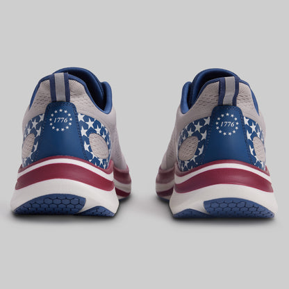 Pair of sneakers with American flag design on a gray background