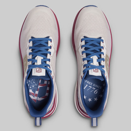 Pair of running shoes with blue laces and American flag design on a gray background