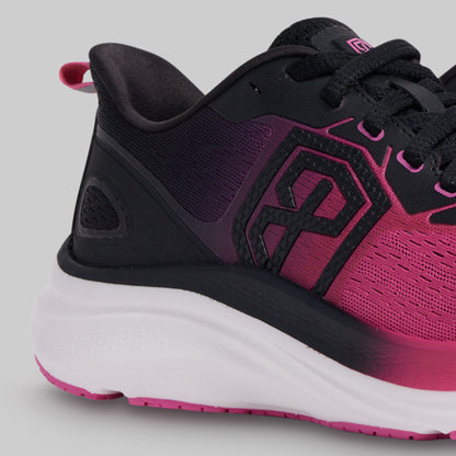 Pink and black athletic shoe on a gray background