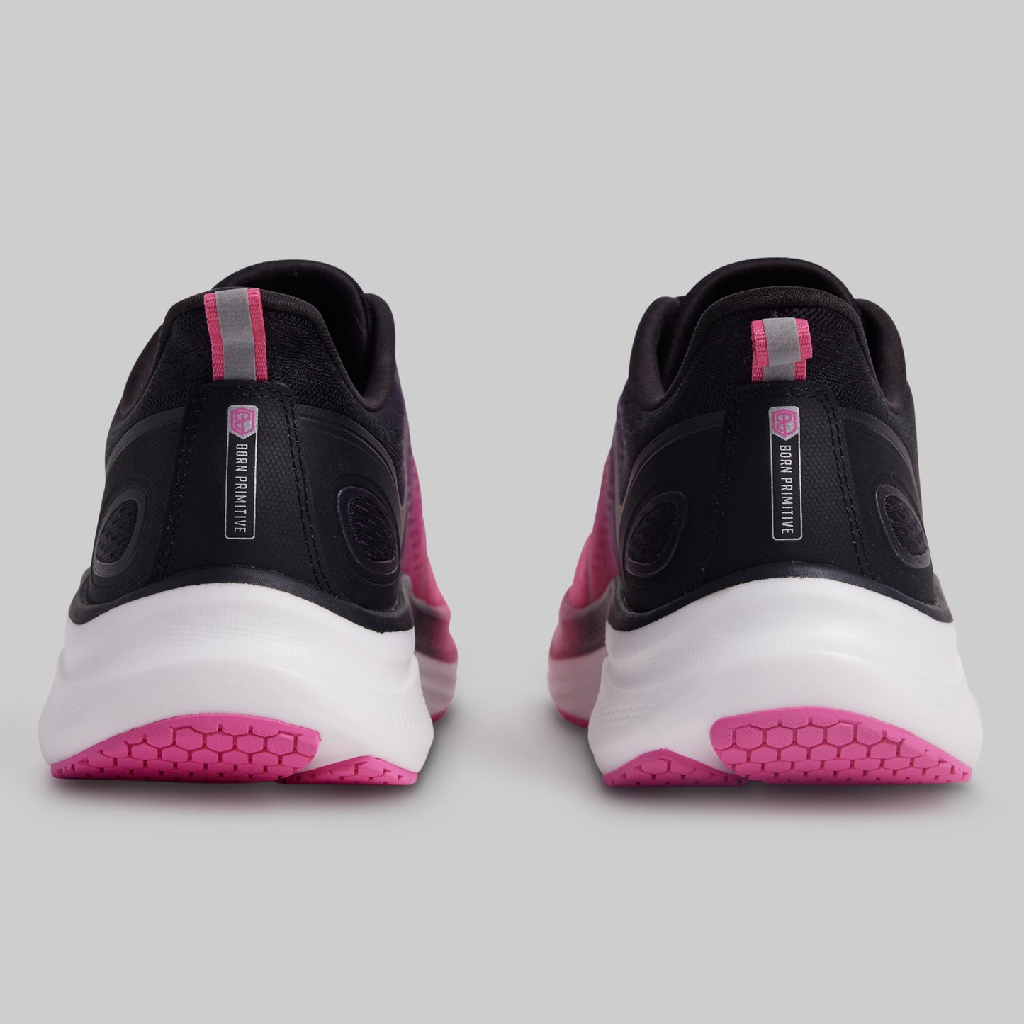 Black and pink athletic shoes on a gray background
