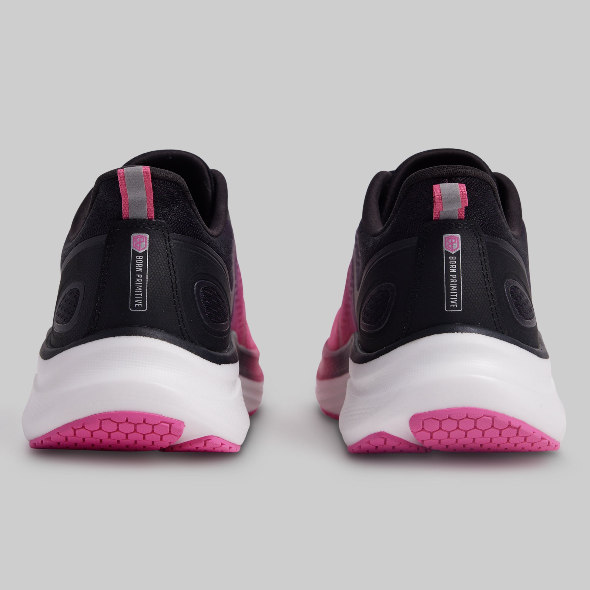 Black and pink athletic shoes on a gray background