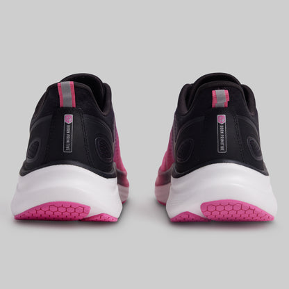 Black and pink athletic shoes on a gray background