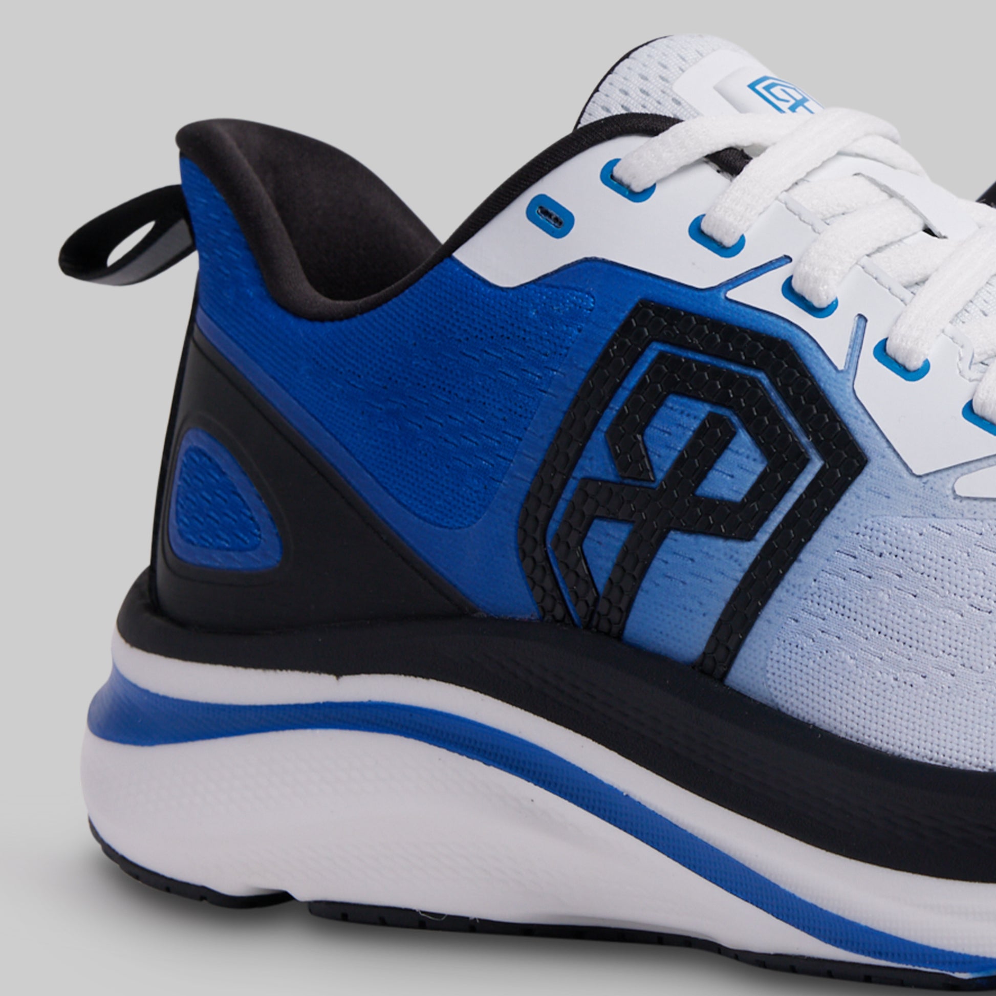 Blue, black, and white athletic shoe on a gray background
