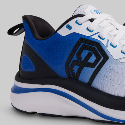 Blue, black, and white athletic shoe on a gray background