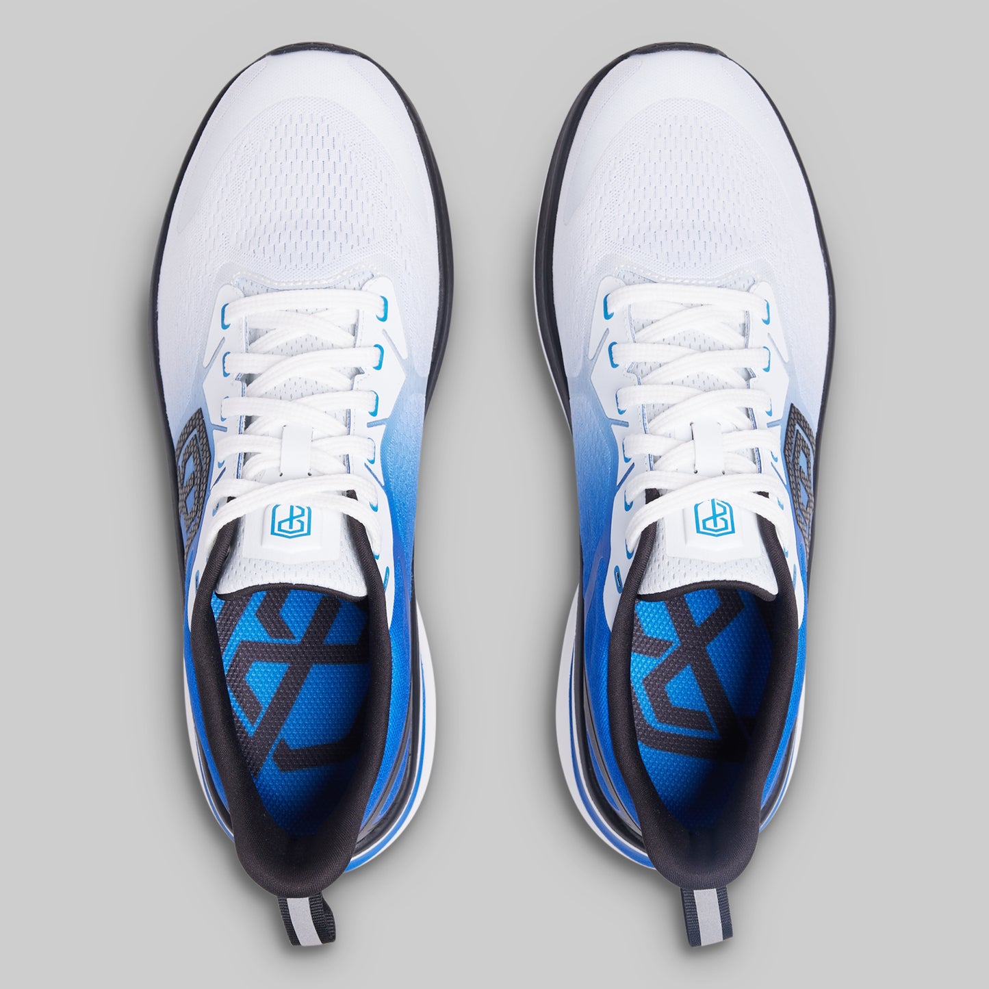 White and blue athletic shoes on a gray background