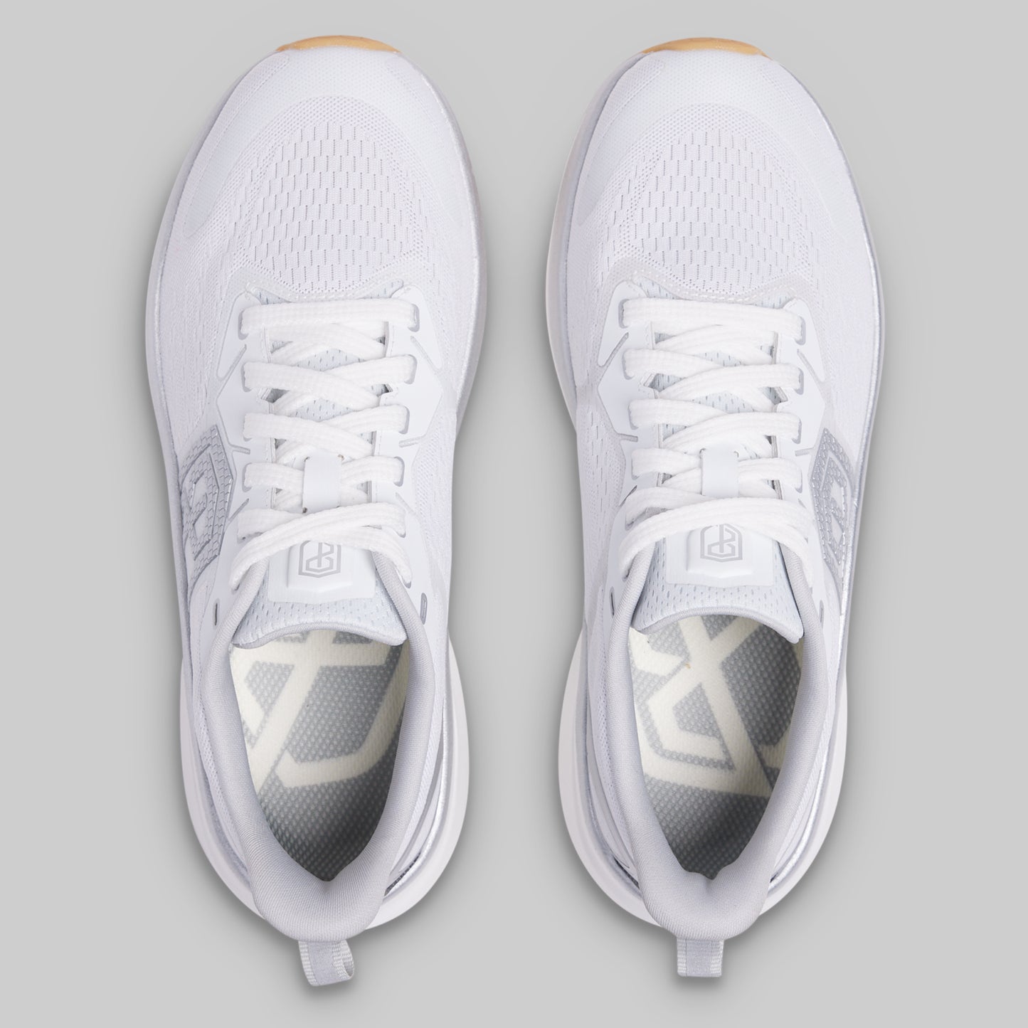 White athletic shoes on a gray background