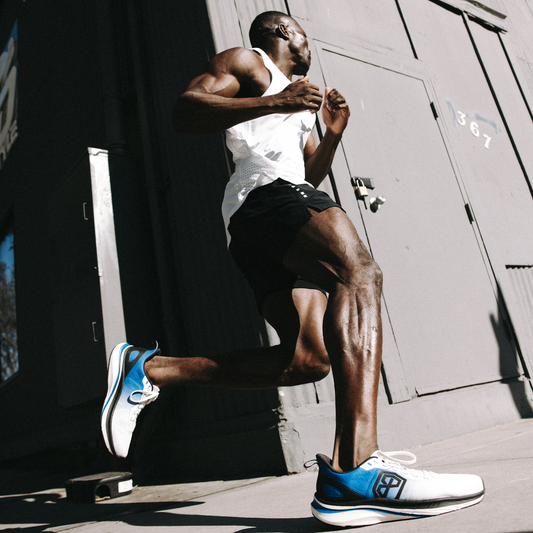 Person running outdoors with a building in the background