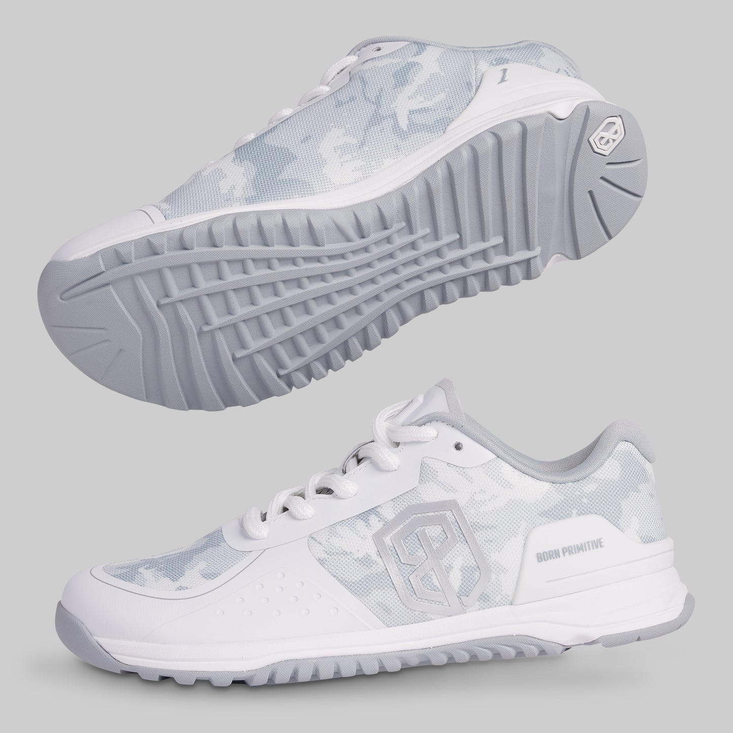 White athletic shoes with gray soles on a light gray background