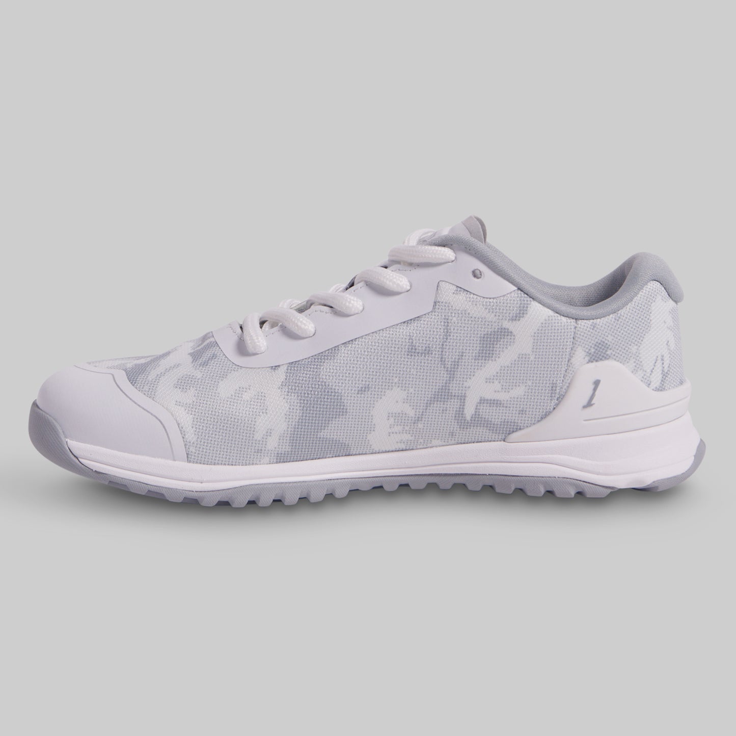 White sneaker with subtle pattern on a light gray background