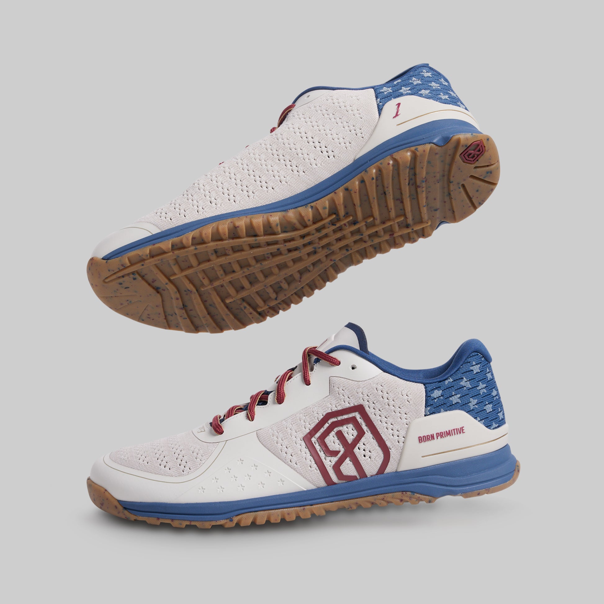 White athletic shoes with blue and red accents on a gray background