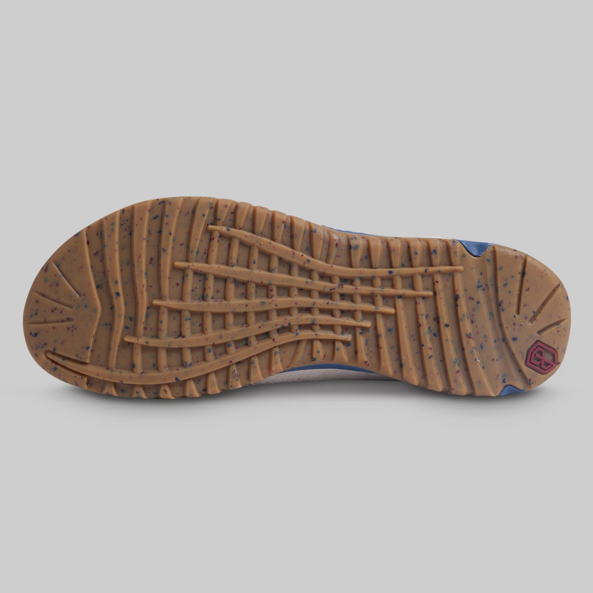 Brown shoe sole with tread pattern on a gray background
