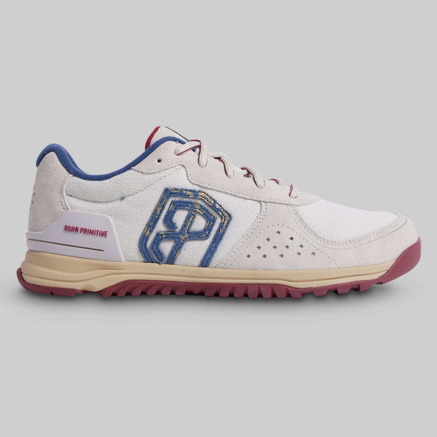 White sneaker with blue and red accents on a gray background