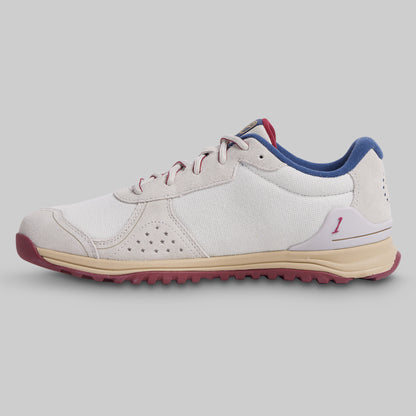 White sneaker with blue and red accents on a gray background