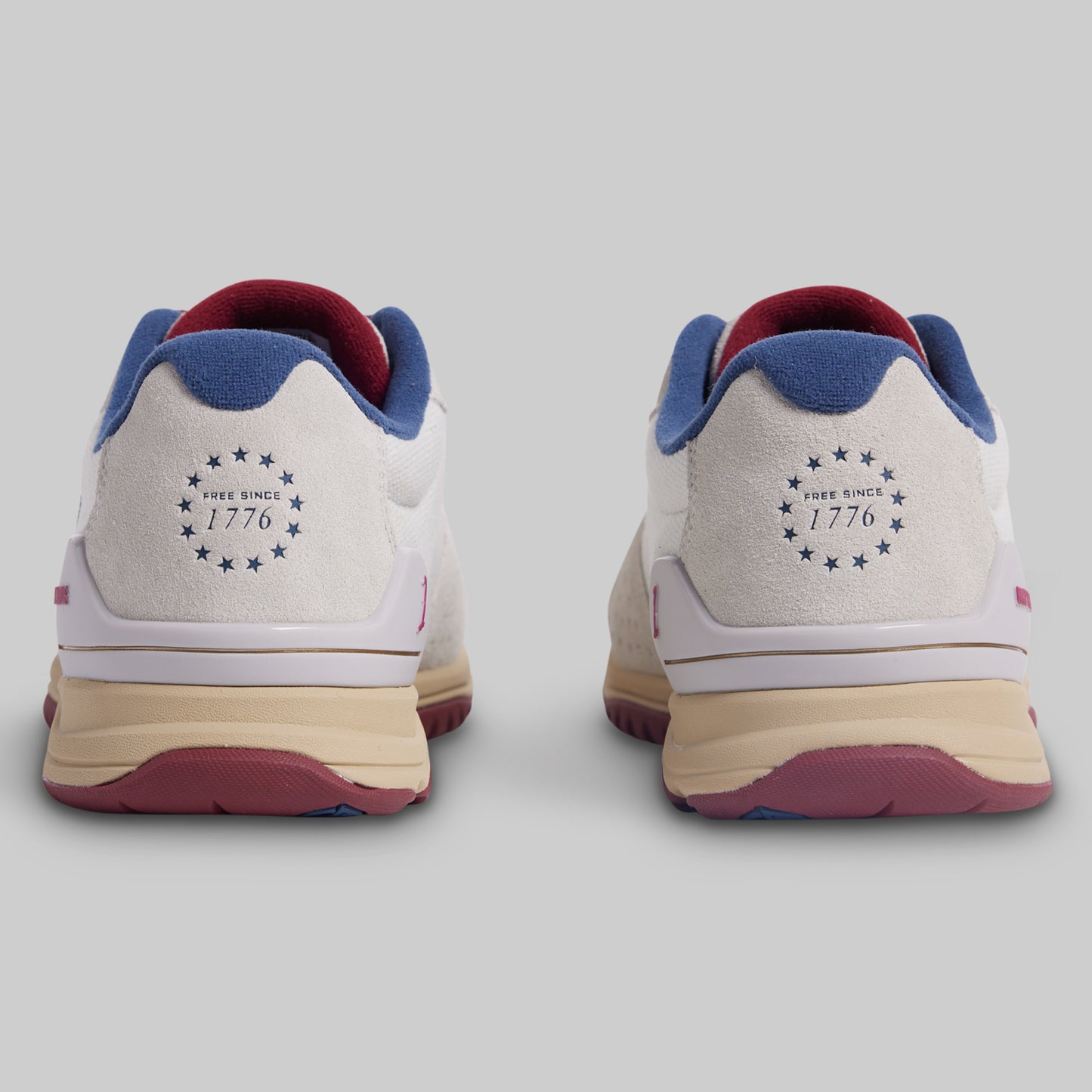 Pair of sneakers with a design on the sole on a light gray background