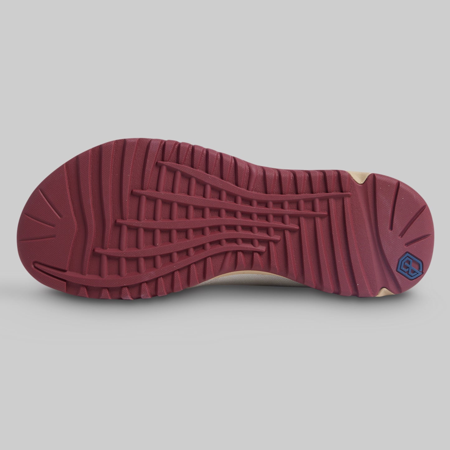 Maroon sole of a shoe on a gray background