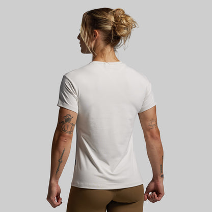 Person wearing a plain white t-shirt against a gray background