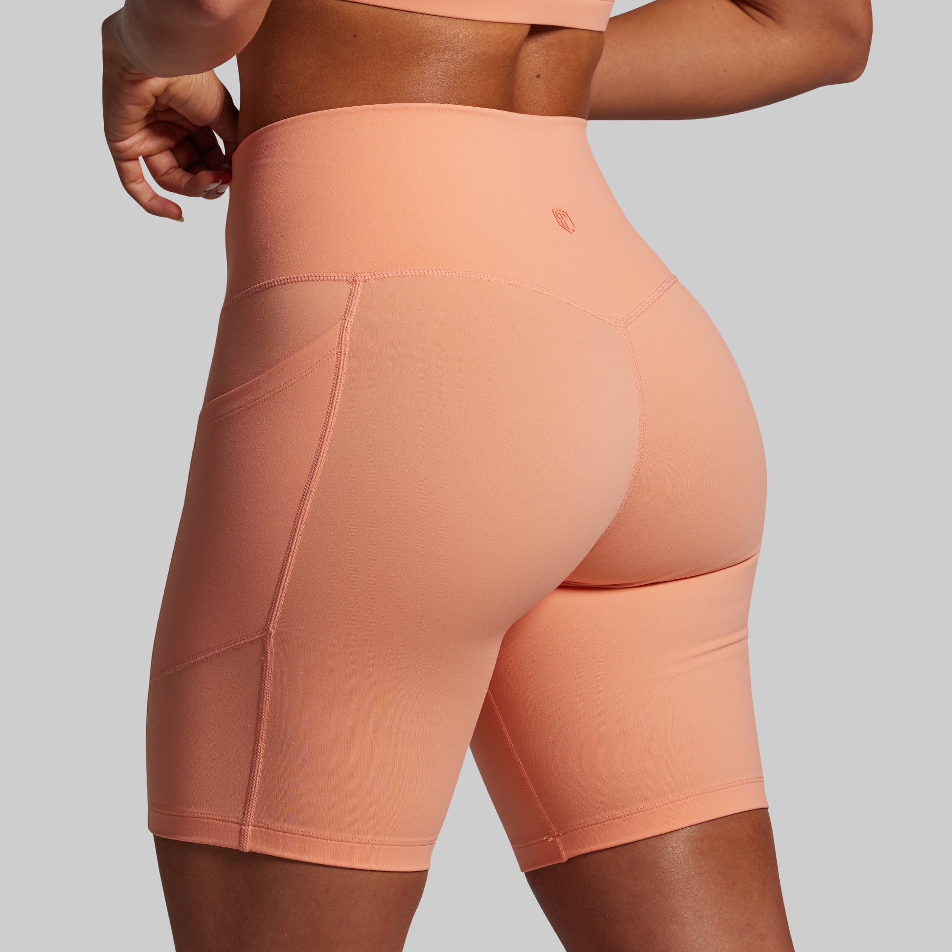 Peach-colored athletic shorts on a plain background