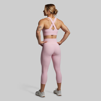 Woman wearing a pink athletic outfit from the back.