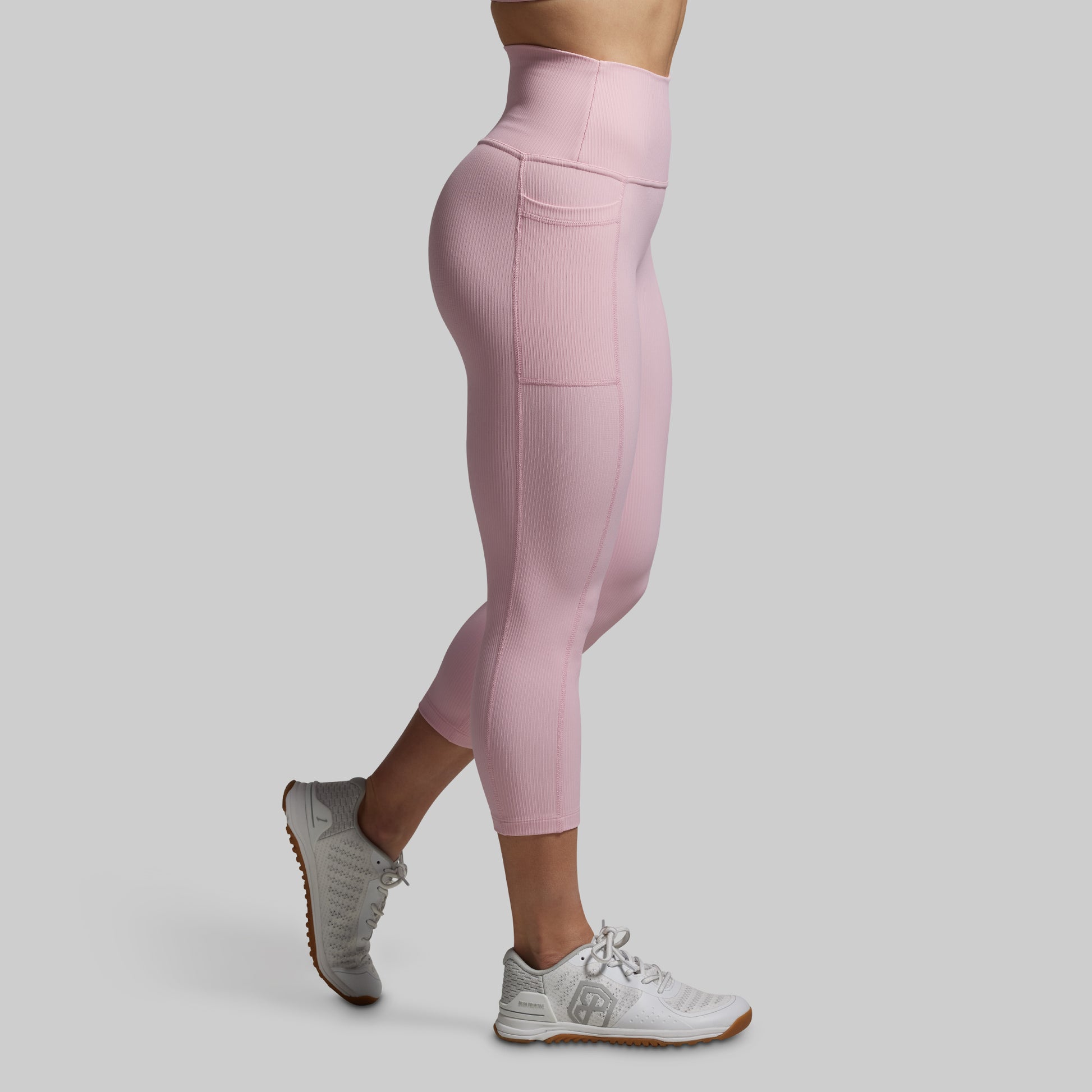 Pink leggings worn by a person on a gray background
