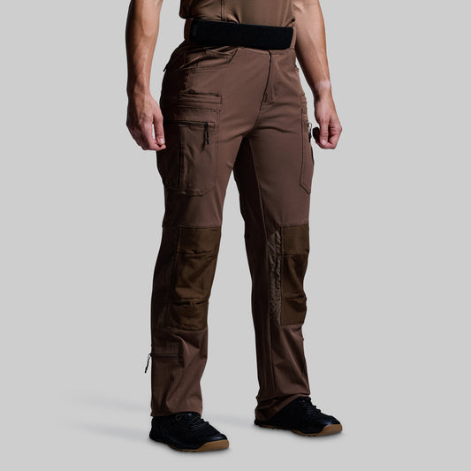 Brown tactical pants worn by a person on a gray background