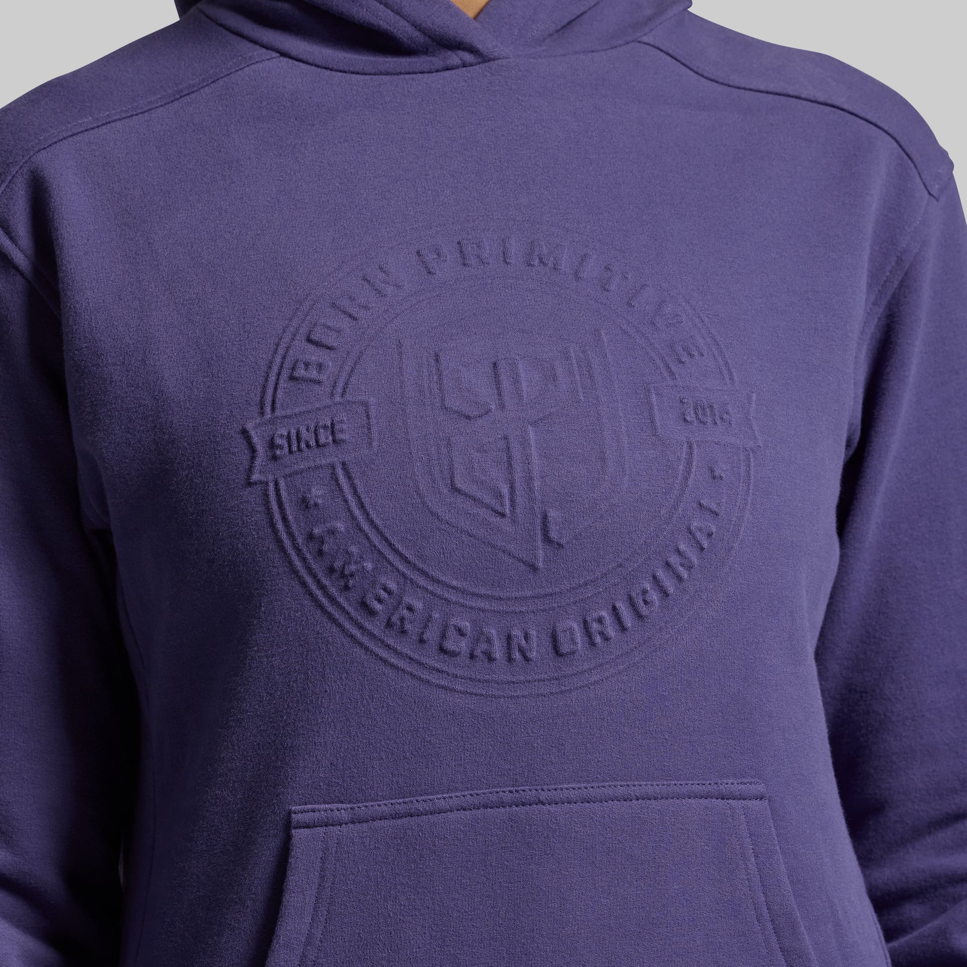 Purple hoodie with a logo on the chest against a gray background