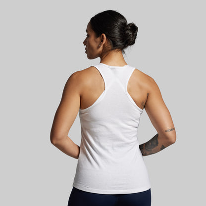 Person wearing a white tank top on a plain background