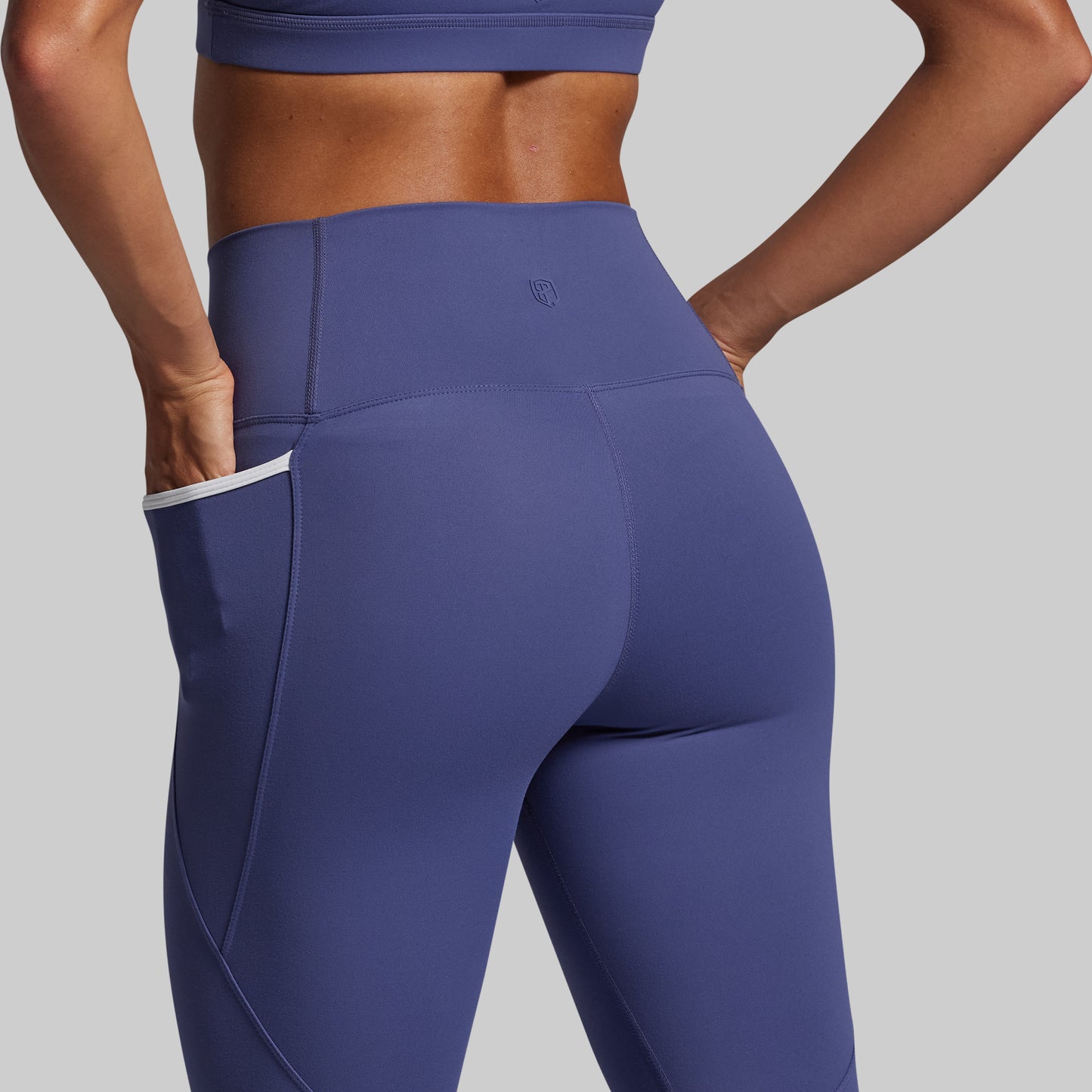 Blue athletic leggings with a gray background