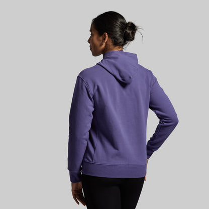 Person wearing a purple hoodie on a gray background