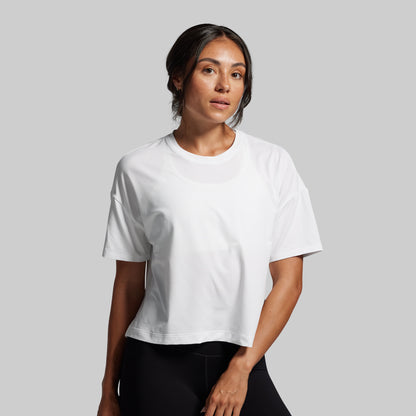 Woman wearing a white t-shirt against a gray background