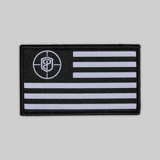 Black and white flag patch with a circular emblem on a gray background