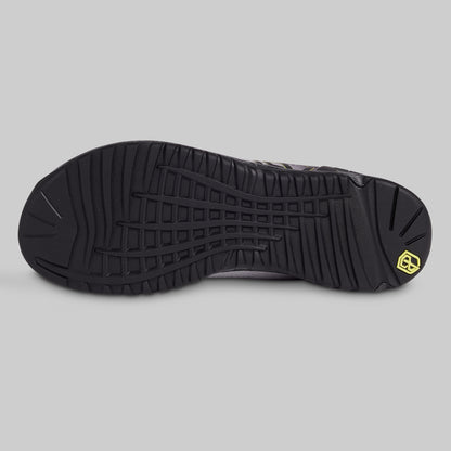 Black shoe sole with a brand logo on a gray background