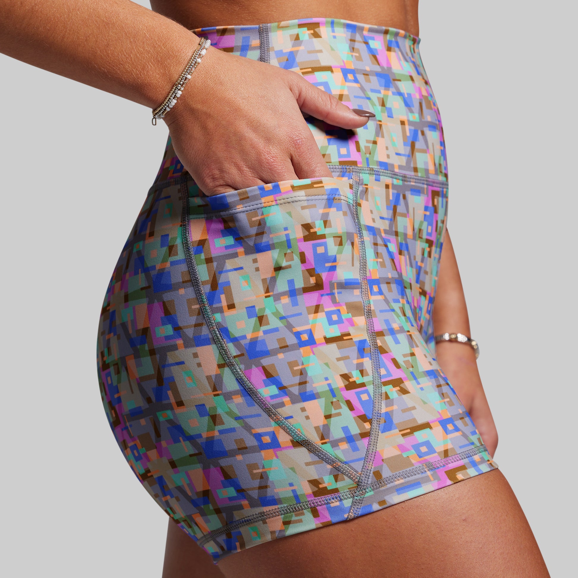 Multicolored geometric patterned shorts on a plain background
