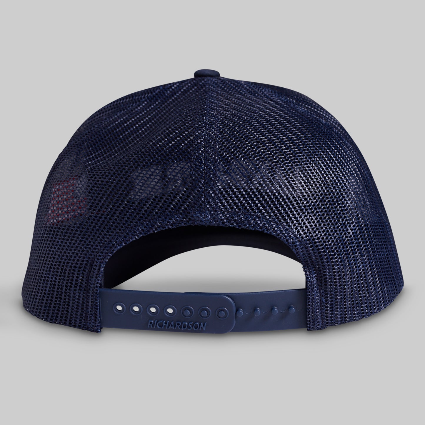 Navy blue mesh cap on a gray background