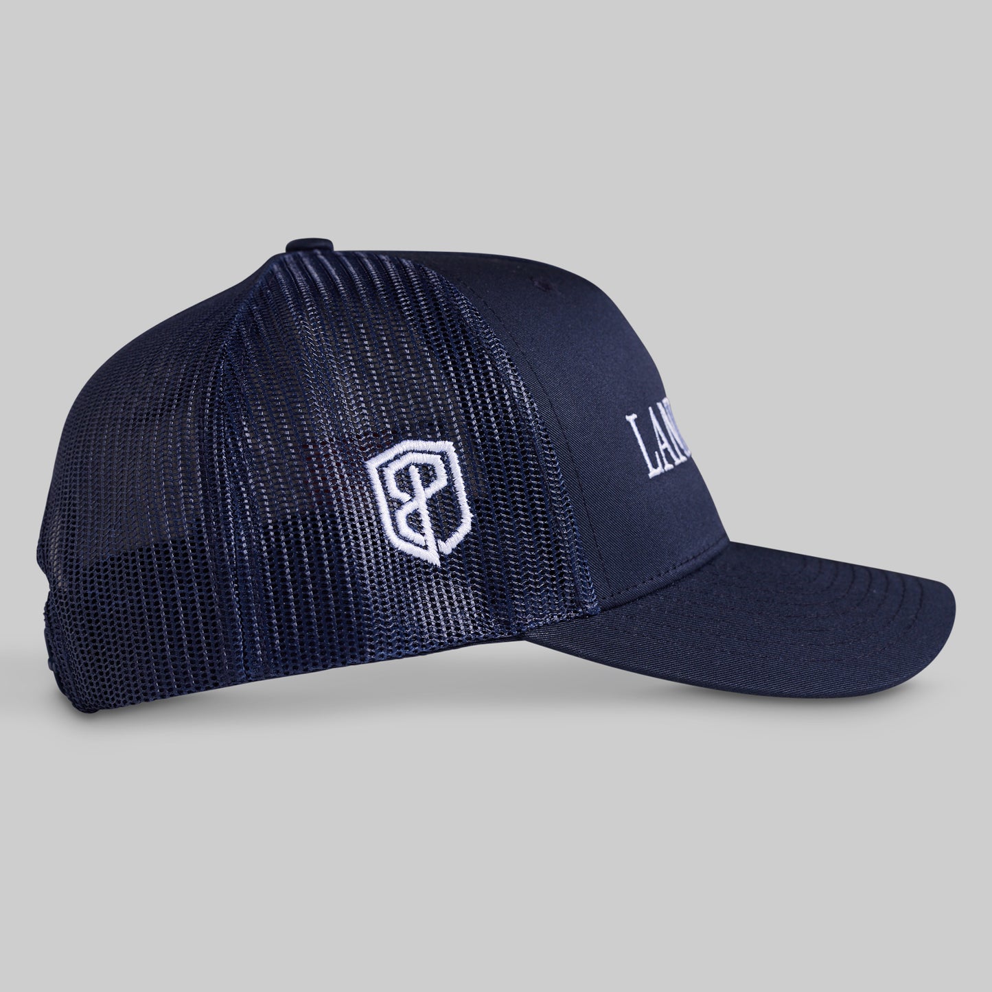 Navy blue cap with a logo on a gray background