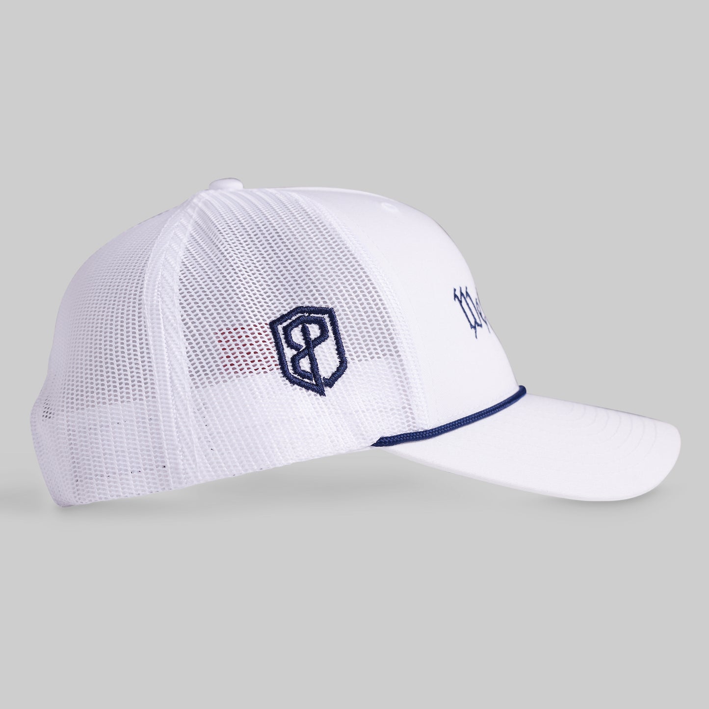 White mesh cap with navy logo on a gray background