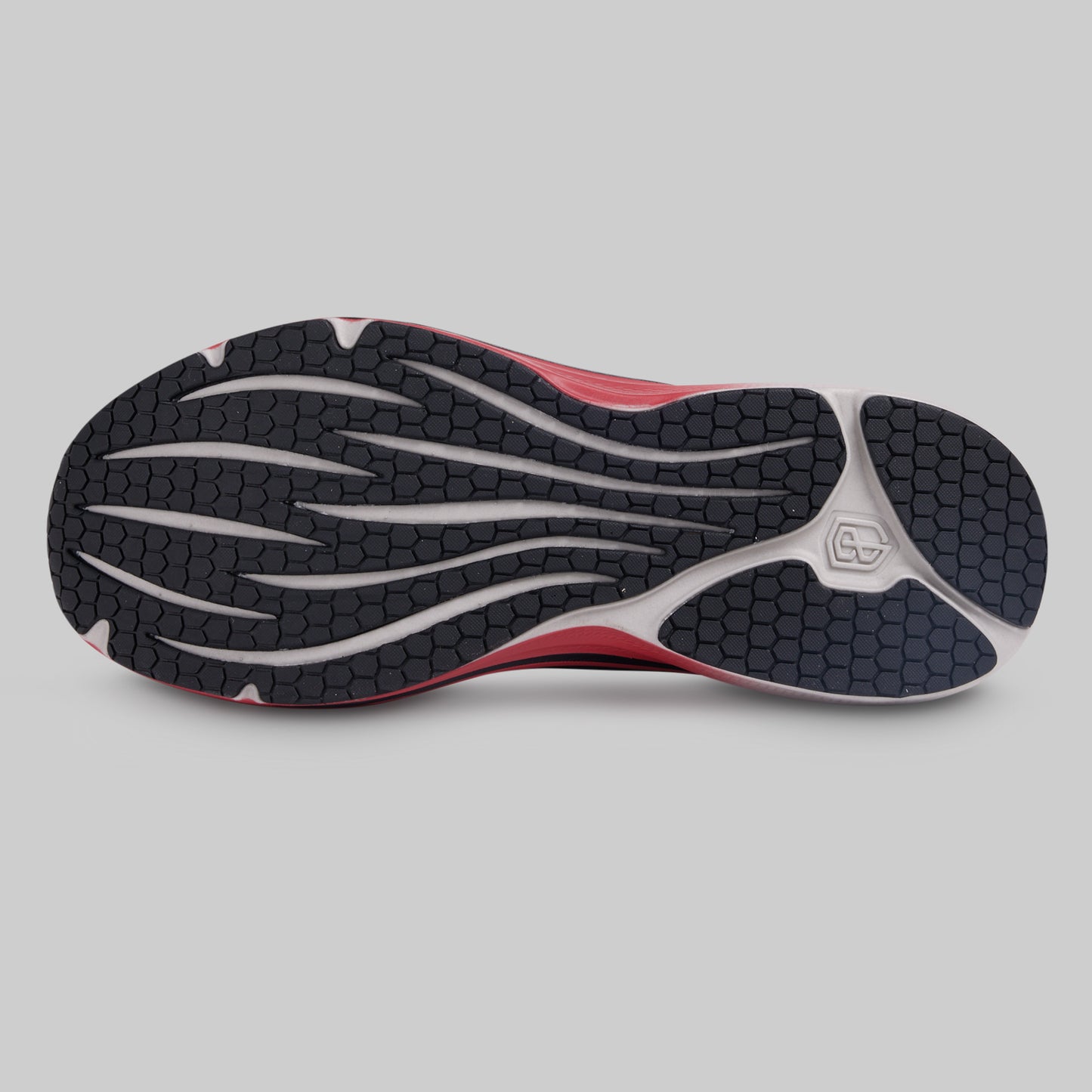 Close-up of a running shoe sole with tread pattern on a gray background