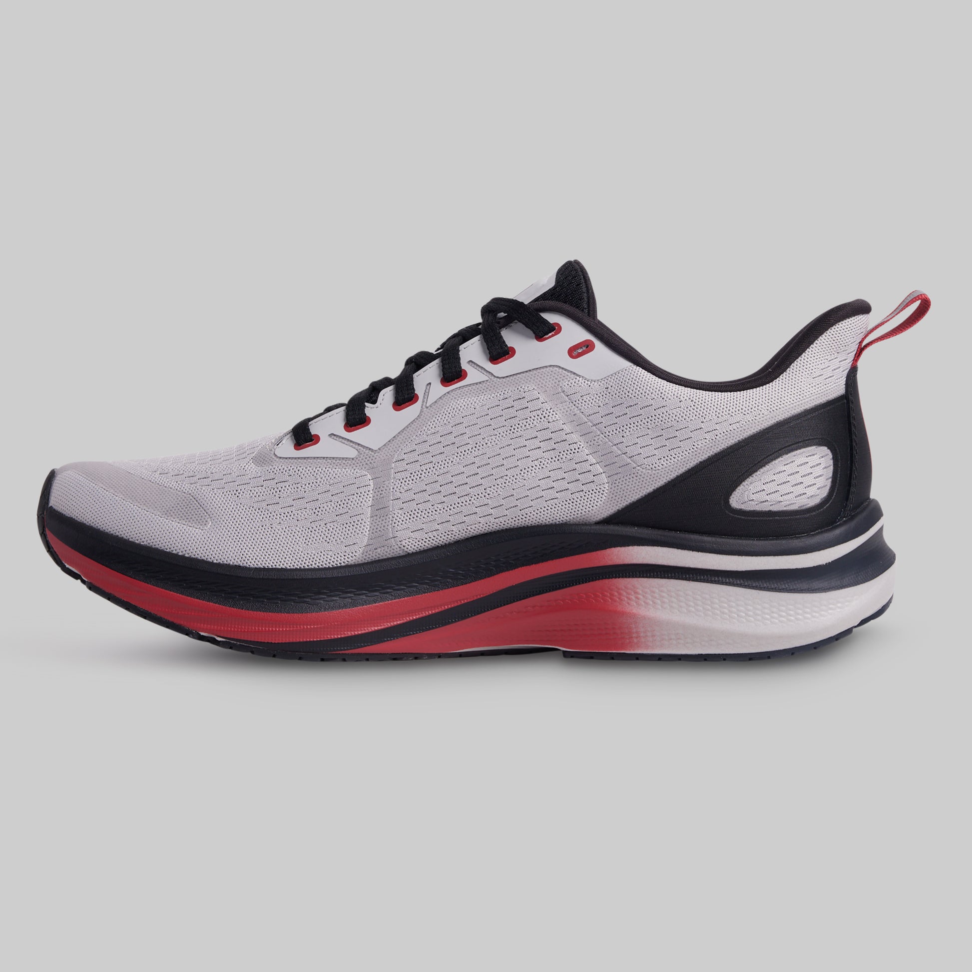 Gray running shoe with black and red accents on a light gray background