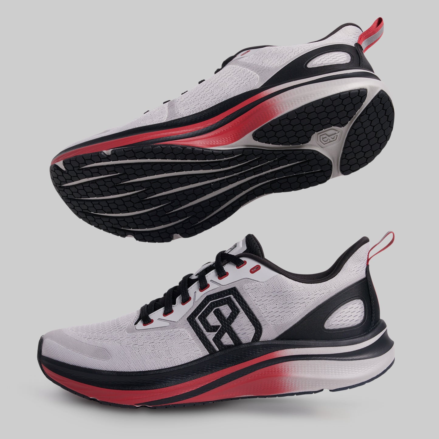 White running shoes with black and red accents on a gray background