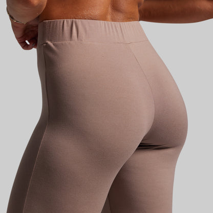 Brown leggings worn by a person on a light gray background